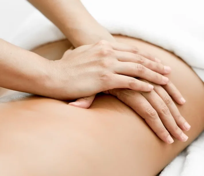 Massage therapist's hands working on a client's back